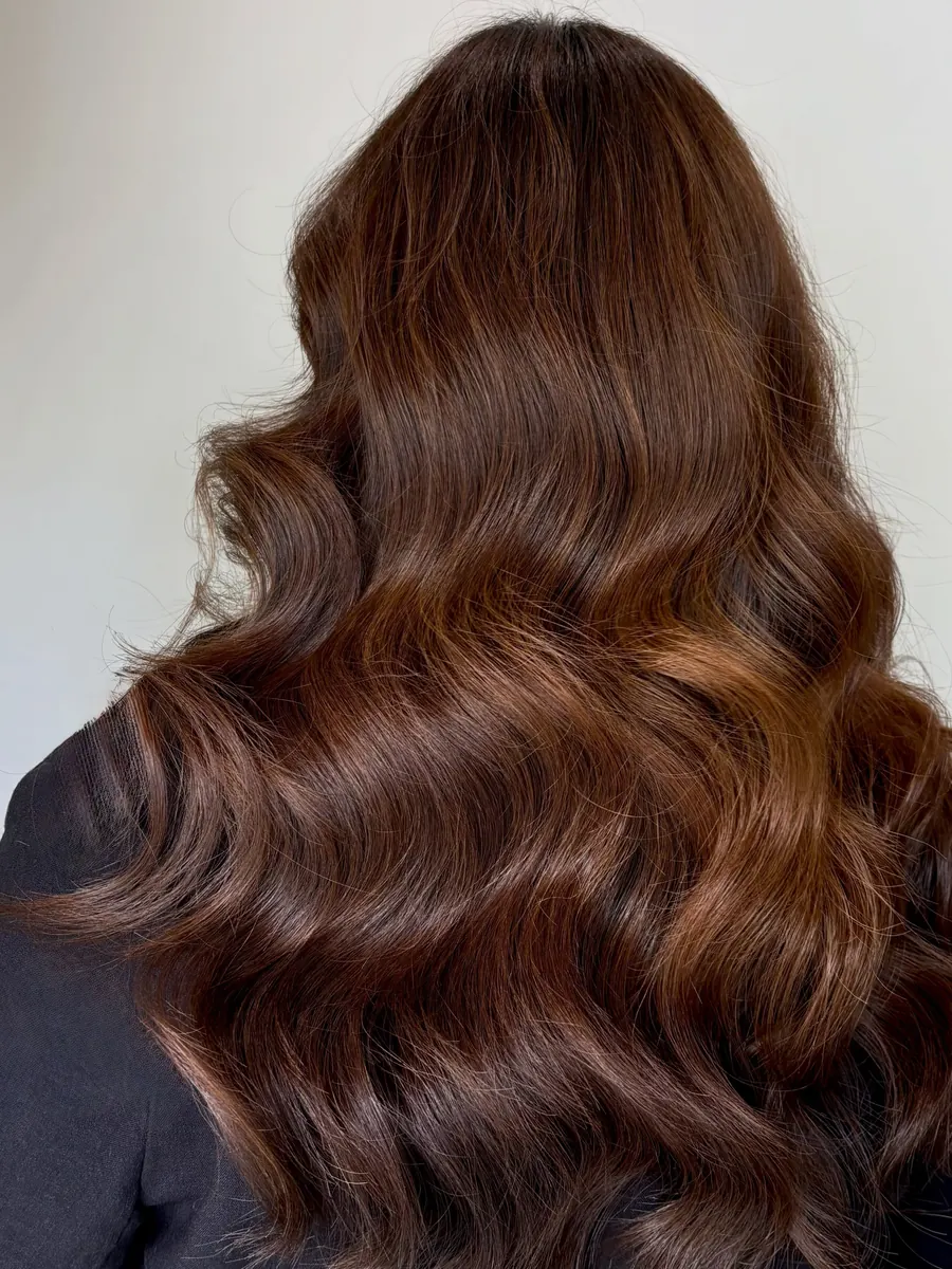 Long hair in a rich copper brown, finished with big glossy waves