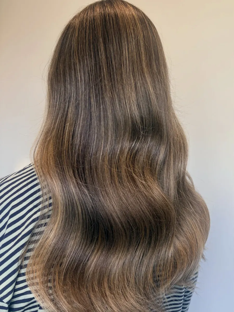 Long hair with soft, blended light-brown dimension through the lengths